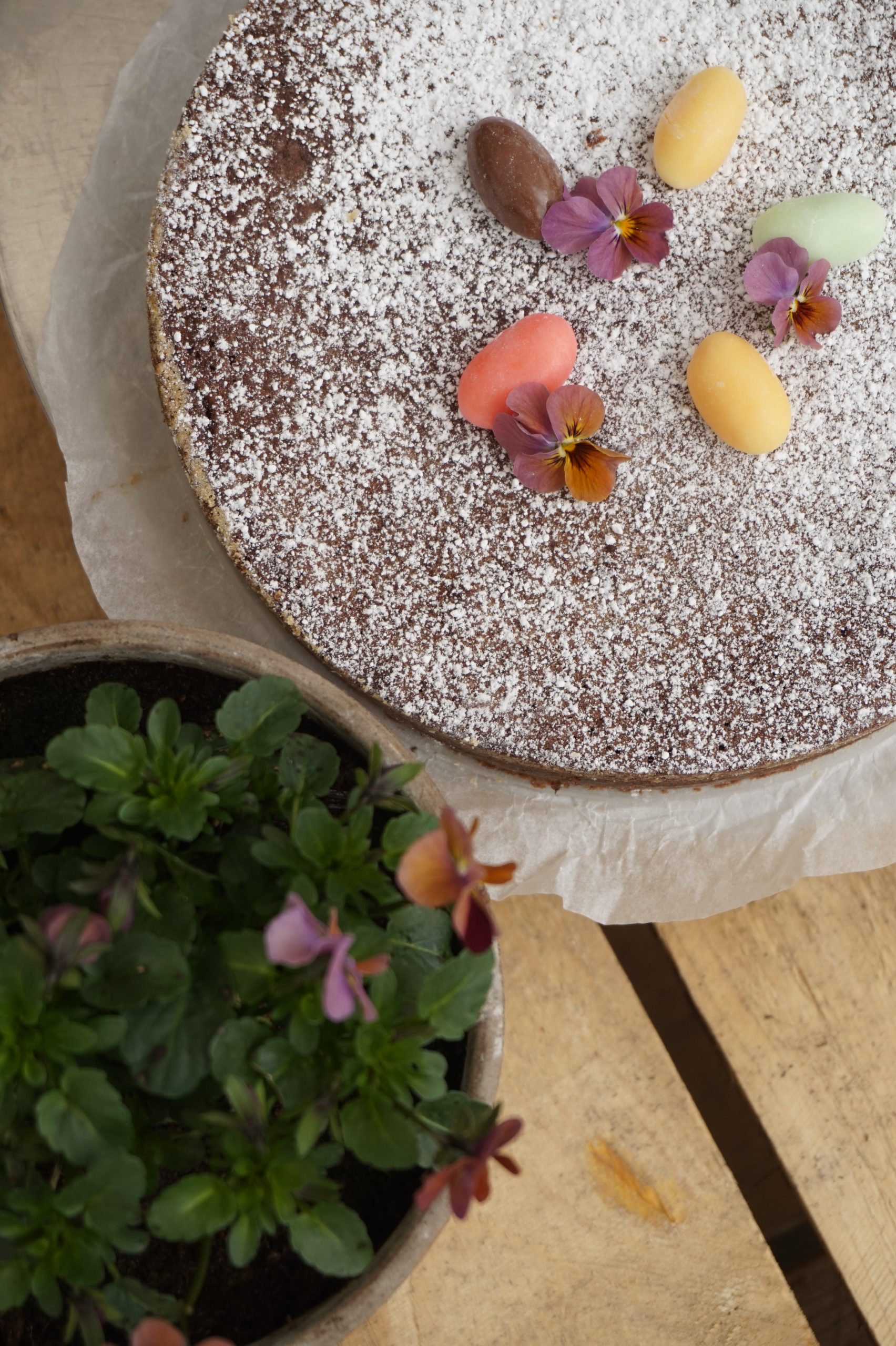 Chocolate cake with flowers and candies